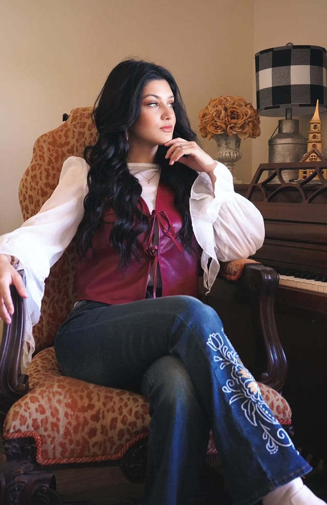 Haley Jones seated at her piano